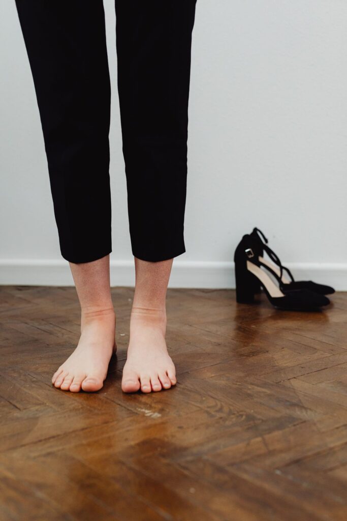 Bare feet resting on a warm wooden floor